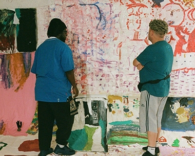 two people looking at art work